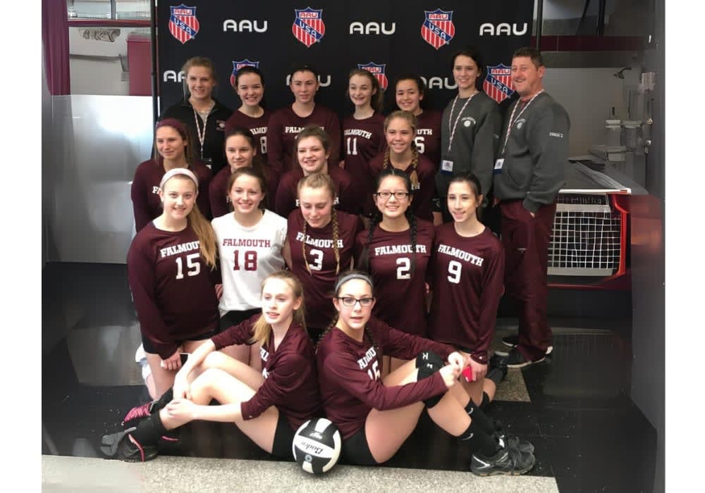 Falmouth AAU girls’ volleyball team in maroon uniforms with coach Frank Zaino