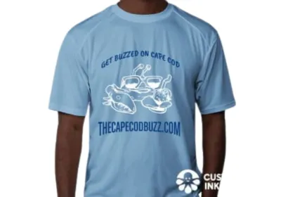 Light blue “Get Buzzed on Cape Cod” T-shirt with crab artwork and THECAPECODBUZZ.COM